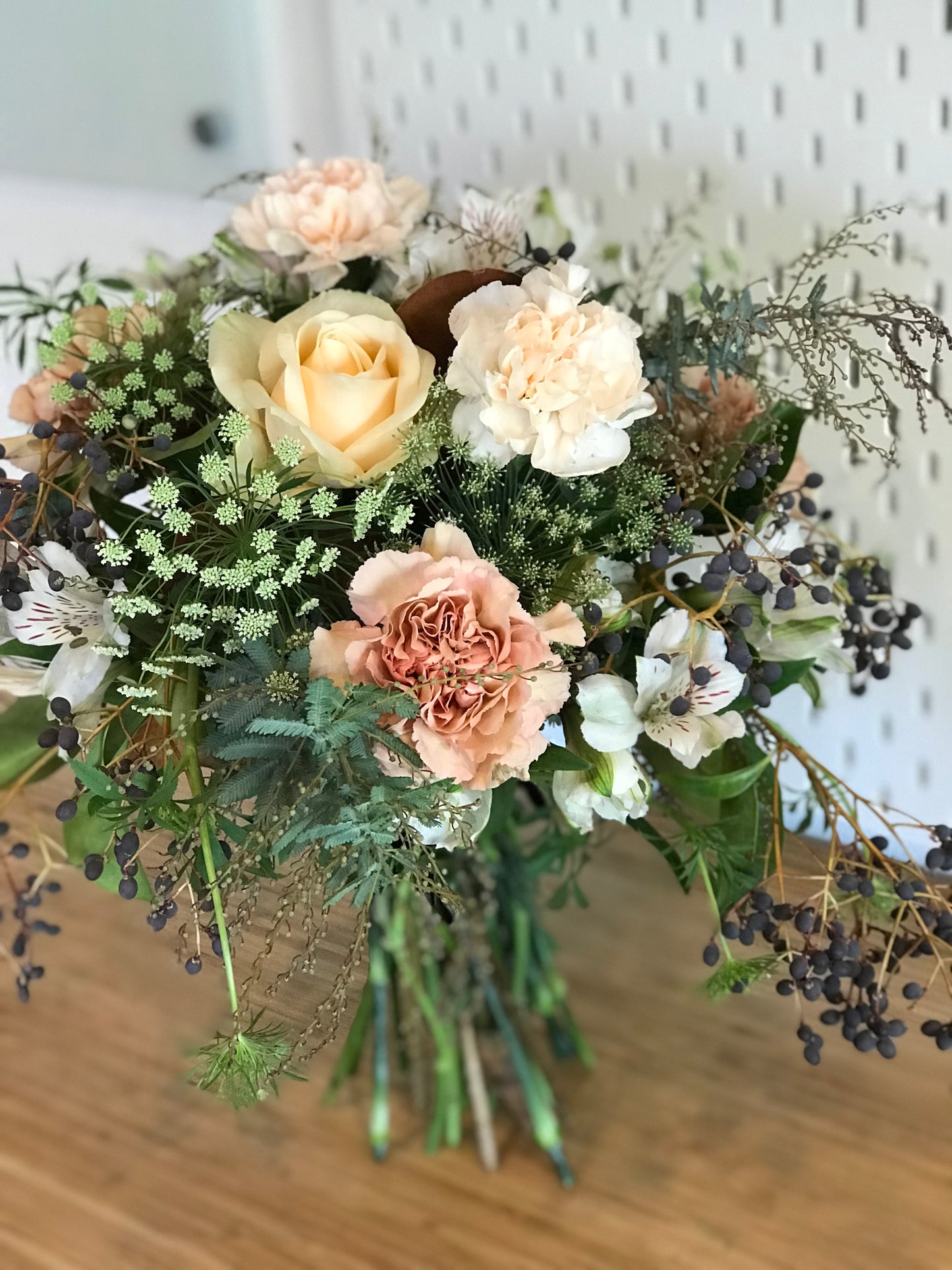 Peach flowers such as roses, carnations, alstroemeria, and locally grown greenery. Flower delivery in woodland and Davis