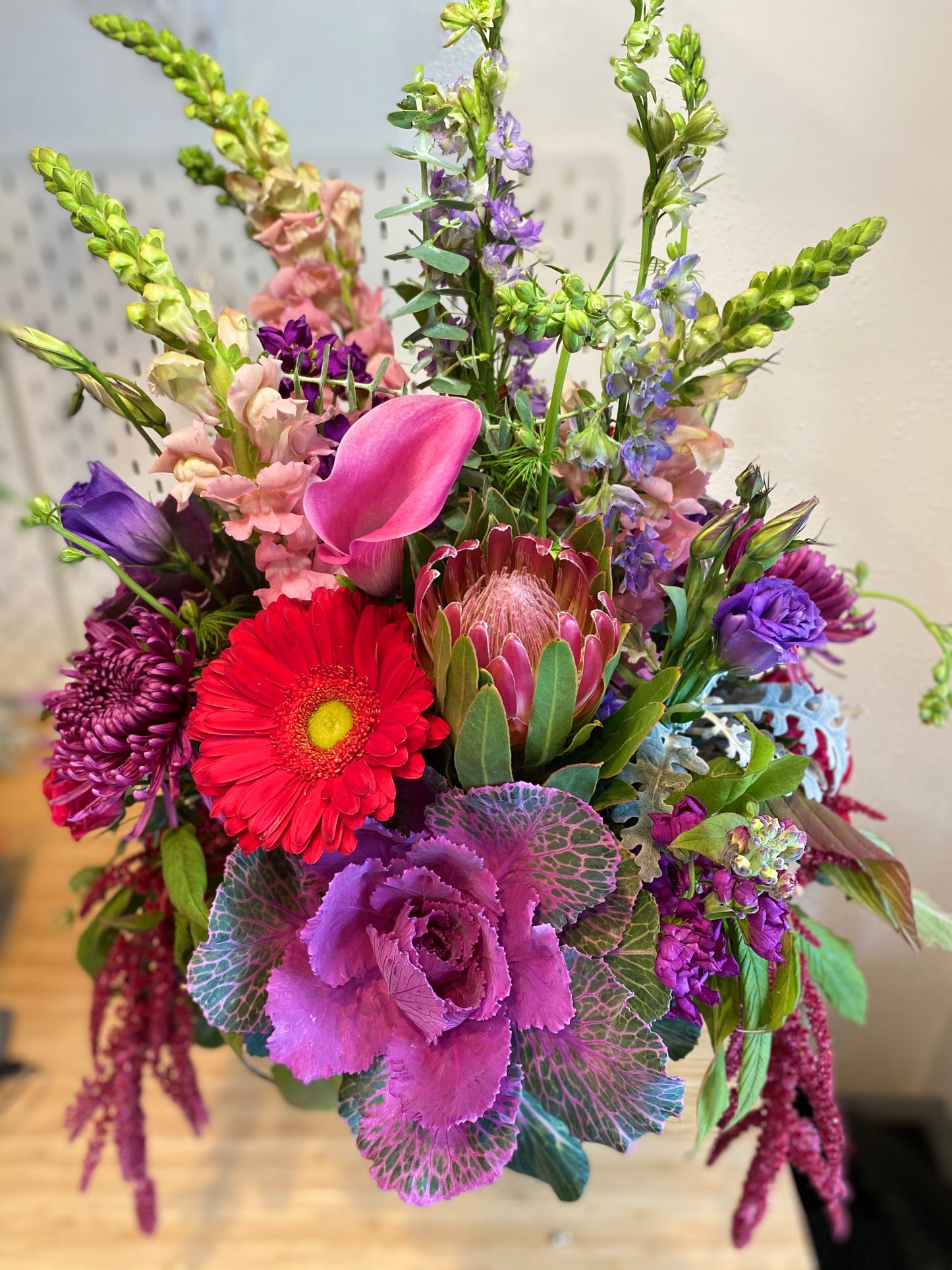 large arrangement of locally sourced flowers such as gerbera daisies, protea, kale, lisianthus, larkspur, snapdragons, stock, eucalyptus delivered in woodland, davis, esparto, knight's landing, valentines day flowers sustainable floristry in yolo county. woman owned
