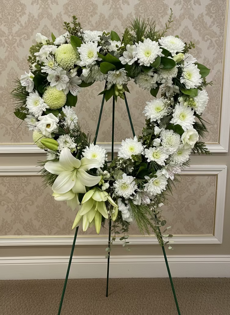 floral white and green heart wreath with a natural park background